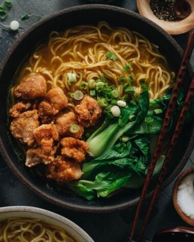 Chinese noodle soup topped with crispy chicken and baby bok choy