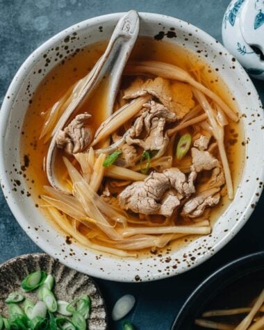 Sliced pork soup with lily flower in a bowl