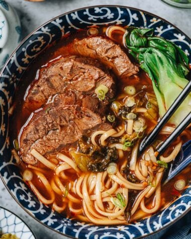 Taiwanese beef noodle soup with bok choy and mustard greens
